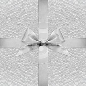 Shiny silver satin ribbon bow on argent