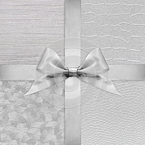 Shiny silver satin ribbon bow on argent photo