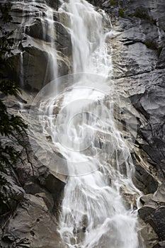 Shiny slow flowing white waterfall cascade