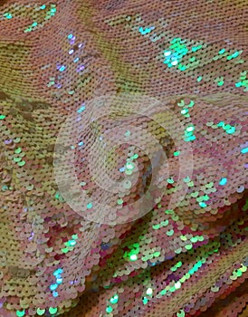 Shiny sparkling fabric with sequins, scales. Background design, photography. Textile, fabric template, modern new