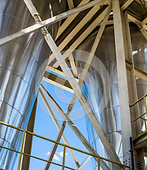 Shiny steel industrial separators on blue sky background