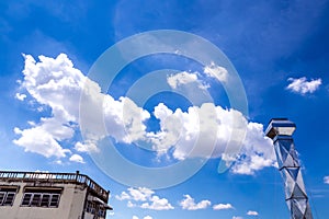 Shiny steel smokestack and cloud in sky