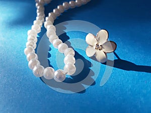 Shiny string of pearls and flower