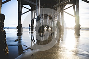 Shiny sun under the pier at Newport Beach, California