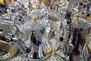 Shiny tea pots Arabian style coffee pods Gold and Silver