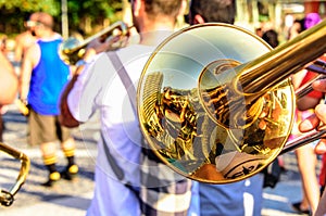 Shiny trombone and blurry musicians playing catchy music at Leme district, Rio de Janeiro, Brazil photo
