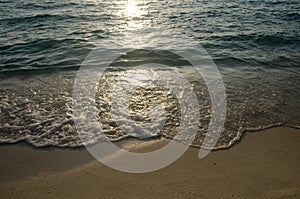 Shiny tropic sea wave on golden beach sand in sunset light,lipe