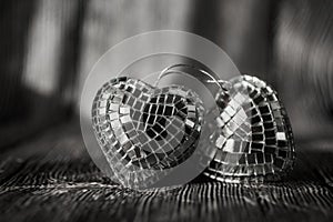Shiny Valentine hearts on old wooden background