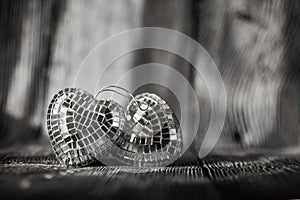 Shiny Valentine hearts on old wooden background