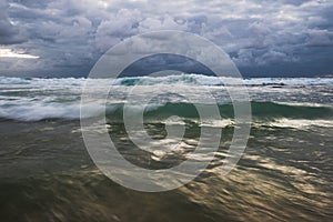 Shiny water seascape with stormy clouds