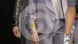 Shiny wristband on model podium defile show. Female vogue fashion runway.