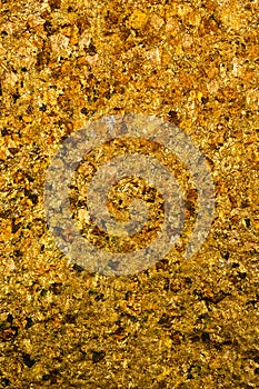 Shiny yellow gold leaf or scraps of gold foil background texture