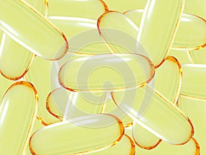 Shiny yellow vitamin omega3 fish oil capsule background.