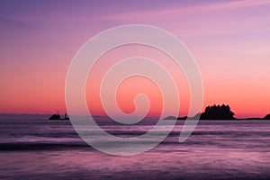 Ship across the ocean at Sunset, in Tofino beach, Canada photo