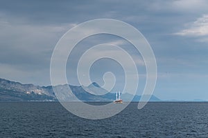 A ship in the Adriatic Sea against the mountainous Croatian coast