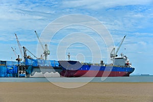 Ship alongside in shipyard near floating dry dock