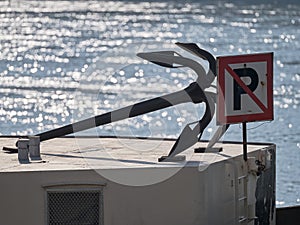 Ship anchor on the boat and no parking sign