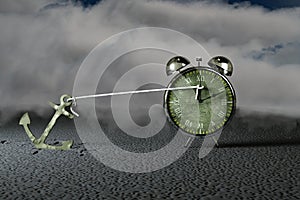 Ship anchor holding a clock indicator.