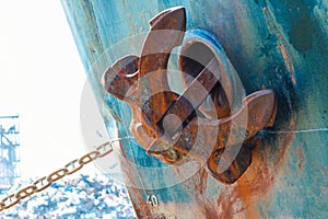 ship anchor in up position. Heavy metal anchor on the side of the ship