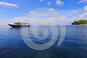 ship anchored in a calm sea in the village of Banda Ely?