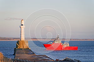 Ship arriving at Aberdeen harbour after passing Girdle Ness Lighthouse