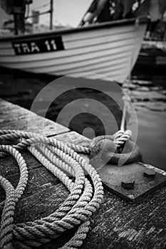 a ship is attached to a bollard in the harbor