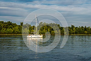 A ship, a barge, a yacht, a boat on the river in the Rostov region. Water transport against the background of a green leafy landsc