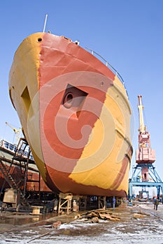 The ship being on repair in a shipyard