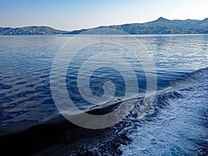 Ship Bow Wake on Calm Blue Sea