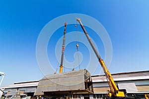 Ship building in dry dock with two craine