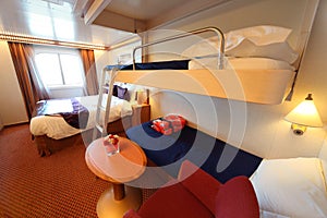 Ship cabin with window, bed and two children beds