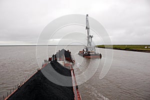 Ship with coal and crane at Kolyma river