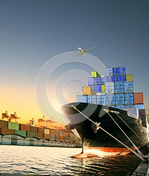 Ship and container box and cargo plane flying over shipping dock photo