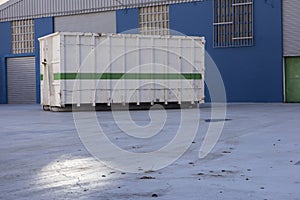 Ship container at the gate of a factory