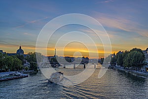 Ship Cruises in Paris From New Bridge With Orange Sky Seine River and Eiffel Tower