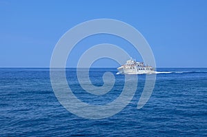 Ship cruising in blue sea