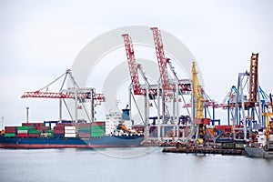 Ship in the dock with elevating cranes