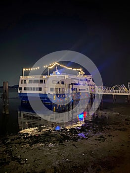 Ship at the edge of the sea port at night.