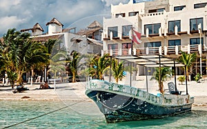 Ship with flag on tropical beach, Costa Maya, Mexico