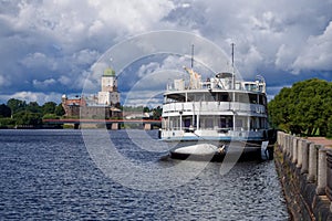 Ship hotel on the background of the old castle in Vyborg