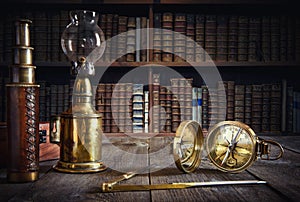 Ship lamp, compass, divider and spyglass on the wood table. Travel and nautical theme grunge background. Retro style. photo