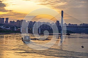 Ship and Lijiatuo Yangtze River Bridge at sunset