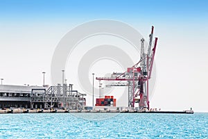 Ship loads containers in the industrial port of Barcelona