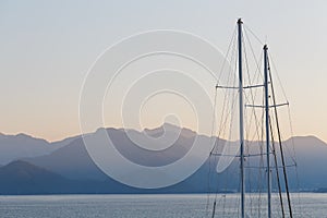 Ship mast on a background of blue sunset sky and mountains