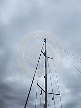 Ship mast on dark cloudy stormy sky background