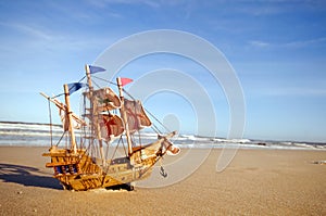 Ship model on summer sunny beach