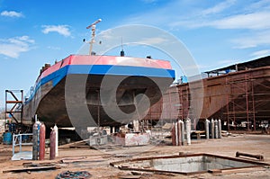 Ship and monumental crane in the shipyard