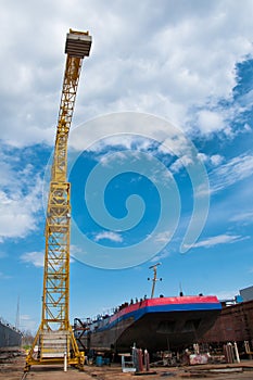 Ship and monumental crane in the shipyard