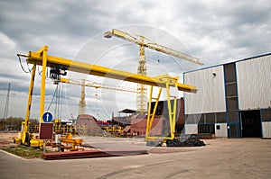 Ship and monumental crane in the shipyard