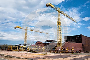 Ship and monumental crane in the shipyard